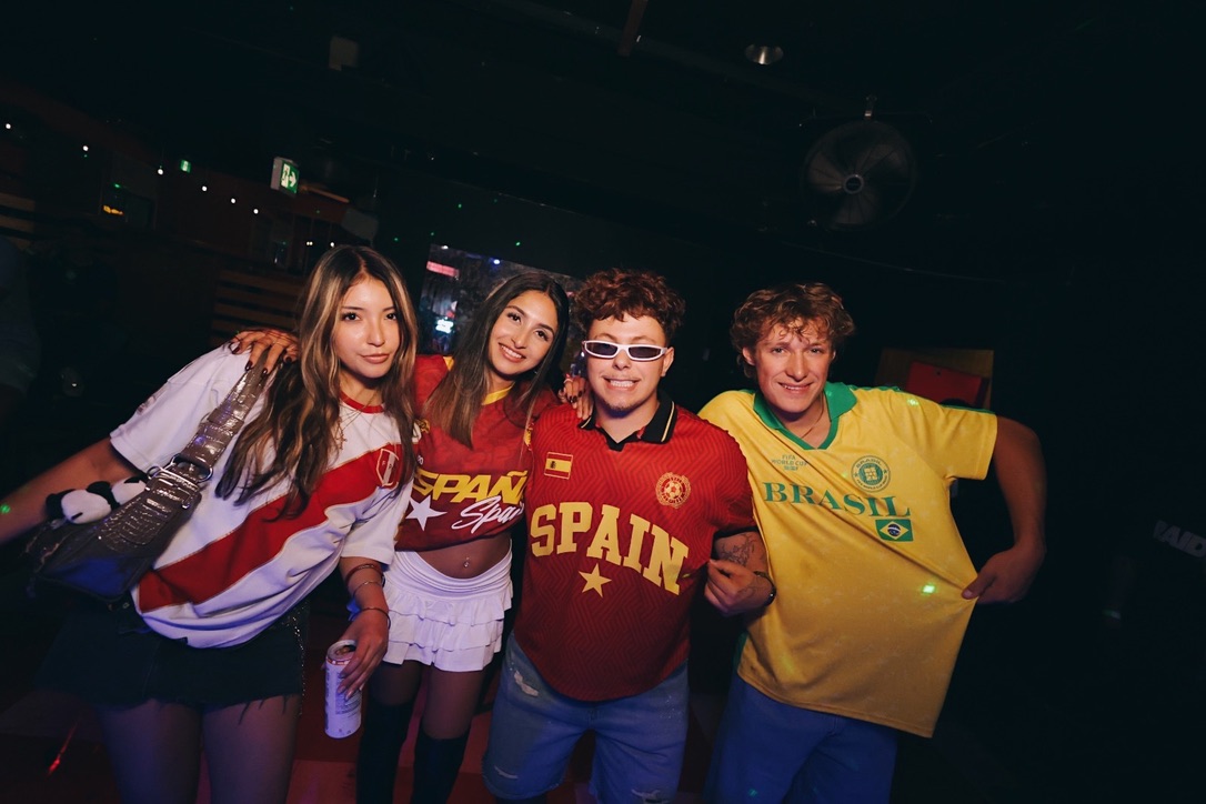 Friends in Brazil and Spain jerseys at a BrazilFeel event